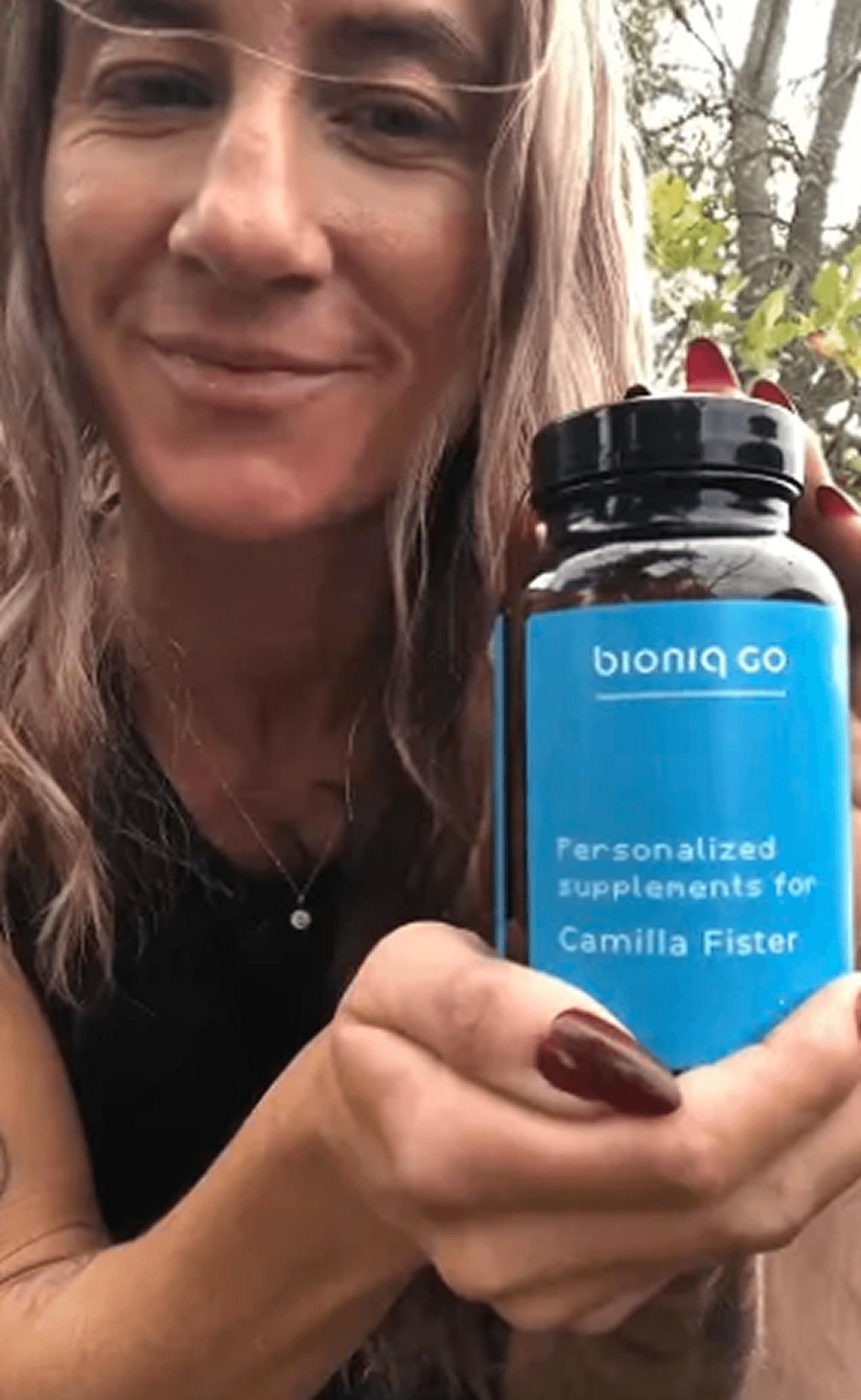 Portrait of woman holding Bioniq bottle